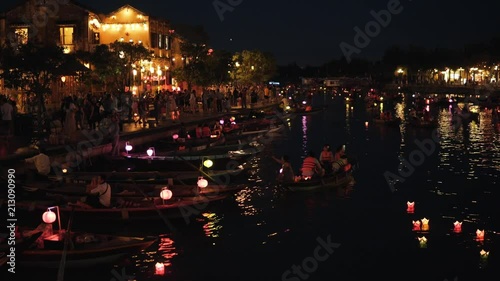 Hoi An, Vietnam - May 10, 2018: Night river Thu Bon view with floating lanterns and boats. Hoi An, once known as Faifo. Hoian is a city in Vietnam and noted as a UNESCO World Heritage Site. photo