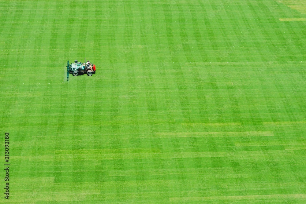 Fototapeta Workers are mowing a football field in Knoxville Tennessee