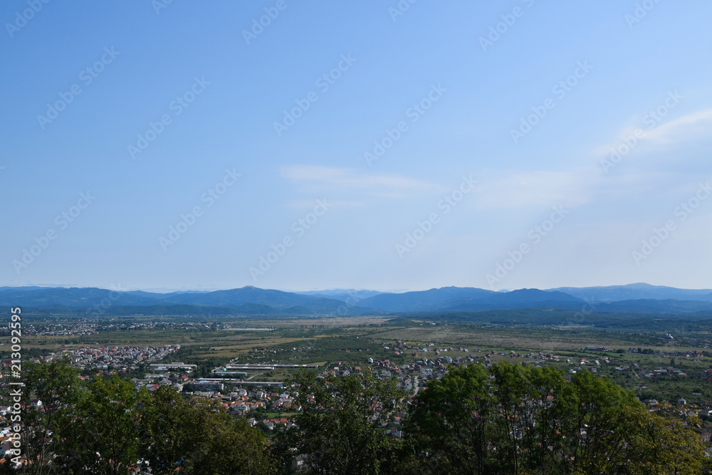Panorama of Khust city in Zakarpattia Oblast. View from ruin of old castle. Landscape, Ukraine.