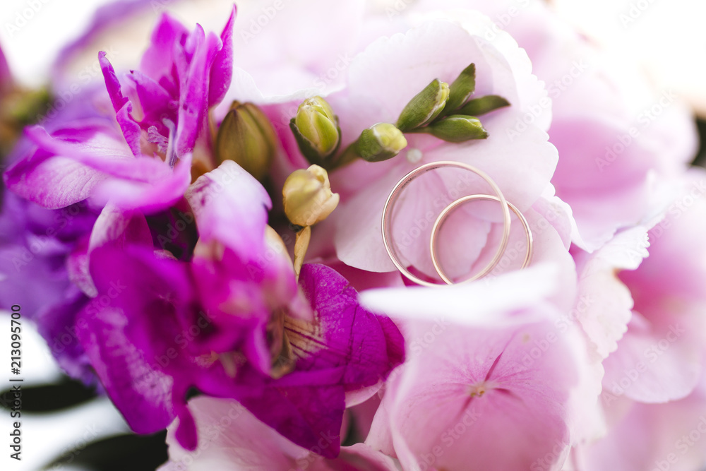 Purple bouquet with wedding rings