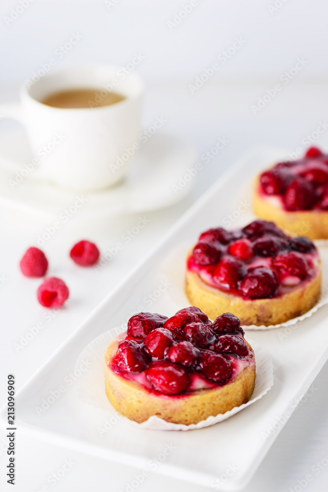 Tartlets with raspberries on a white plate Tartlets with raspberries on a white plate