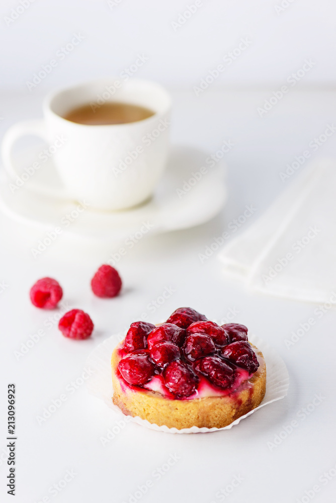 Tartlets with raspberries and a cup of green tea Tartlets with raspberries and a cup of green tea
