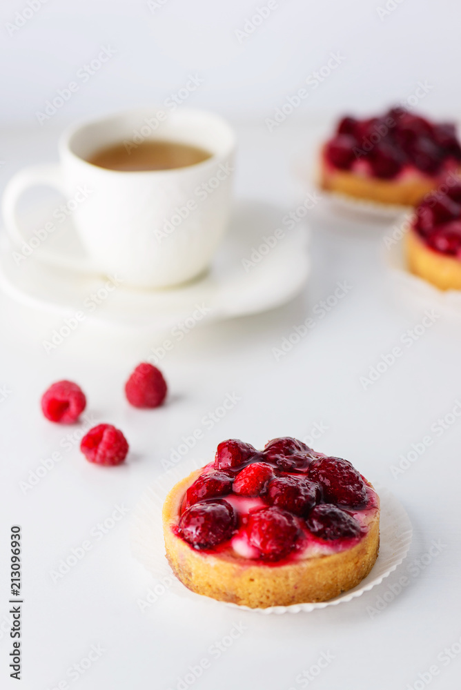 Tartlets with raspberries and a cup of green tea Tartlets with raspberries and a cup of green tea