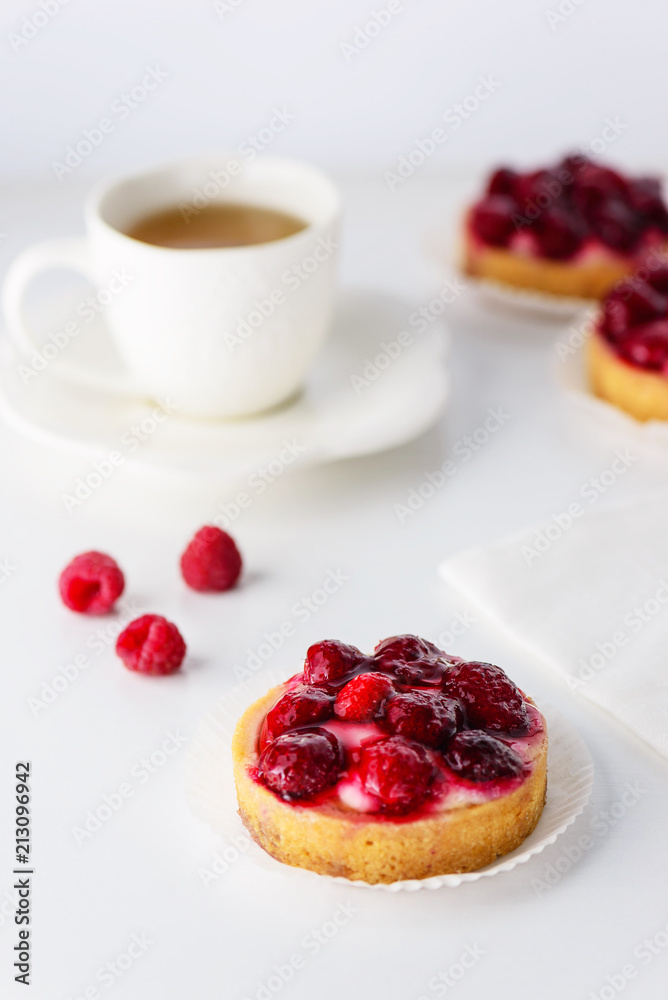 Tartlets with raspberries and a cup of green tea Tartlets with raspberries and a cup of green tea
