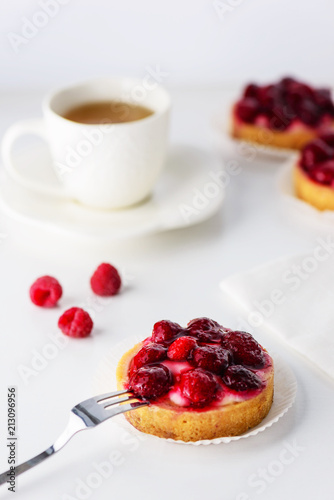 Tartlets with raspberries and a cup of green tea