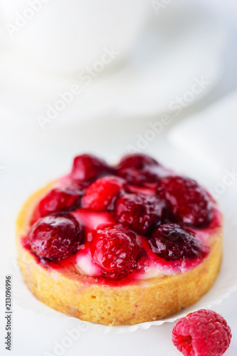 Tartlet with raspberries and a cup of green tea