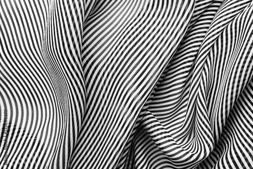 Elegant black and white silk with stripes, abstract background.
