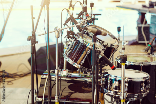 Modern drum set on stage prepared for playing.