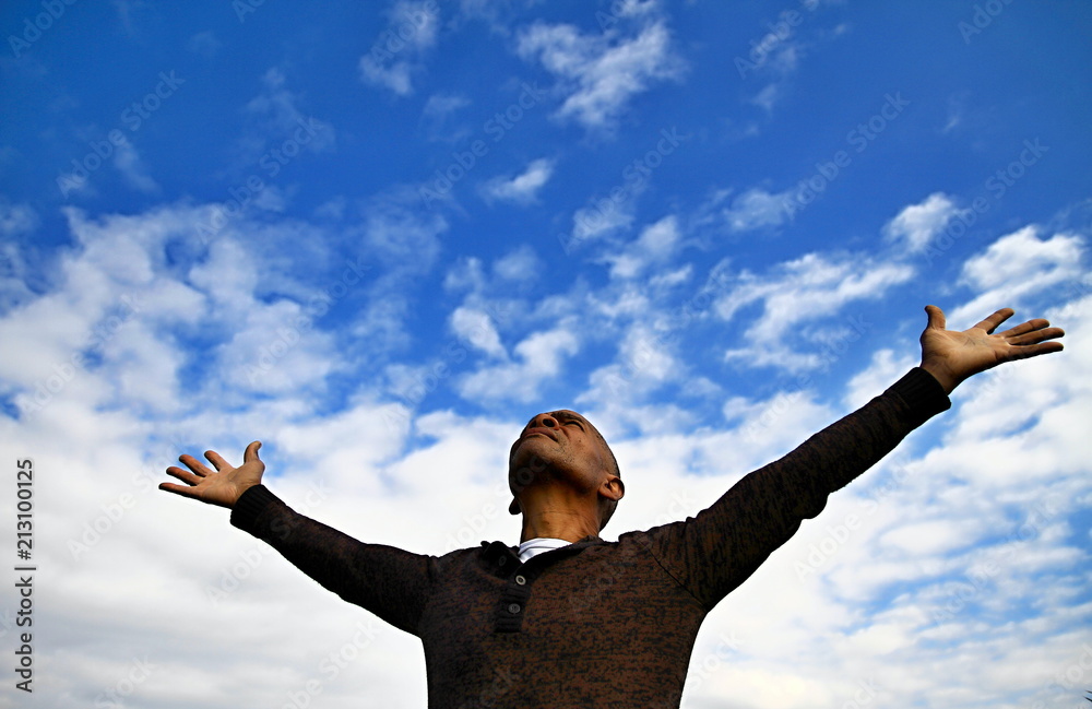 praying with arms outstretched Stock Photo | Adobe Stock