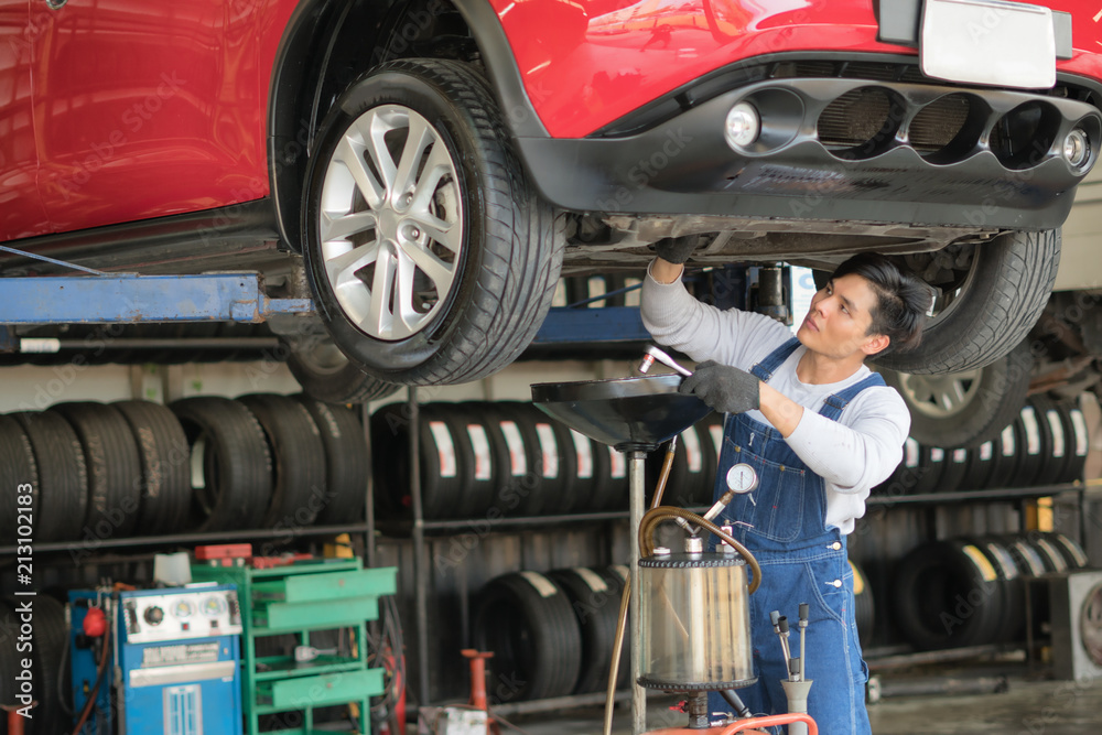 Fototapeta premium Car engine oil repair shop in car garage.