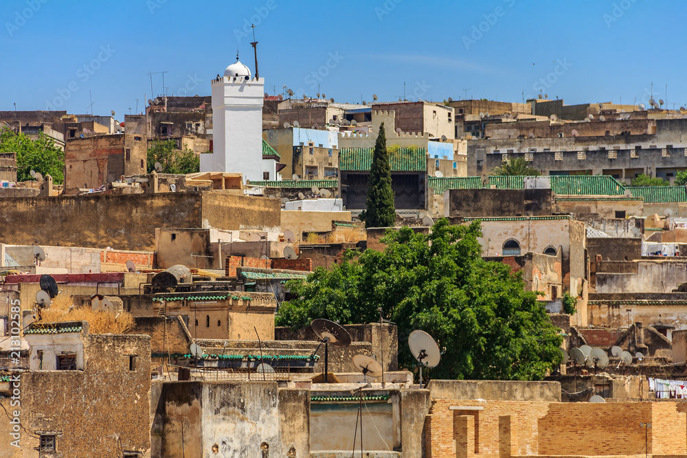 View over the ancient rooftops of the Fes medina with a mosque