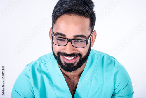 Closeup portrait of cheerful happily smiling handsome young paramedic (doctor, surgeon or nurse), on white background