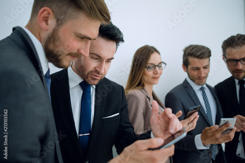 business team looking at the screens of their smartphones