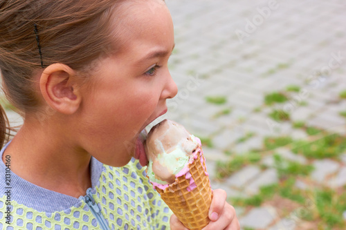 A little girl is eating ice cream.