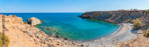 Unique panoramic view of secluded remote bay pebble beach at Mediterranean Makrigialos summer resort  southeast coast Crete Greece. Blue sky, crystal clear turquoise waters. Travel destination concept photo
