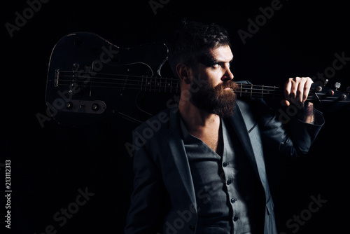 Concert concept. Rock or punk music concert. Bearded man with guitar to give concert. Hipser with musical instrument, concert tour photo