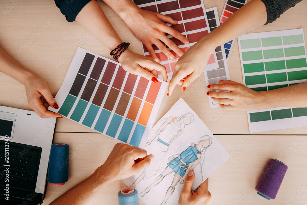 Fashion designers and colorists creating new collection in studio