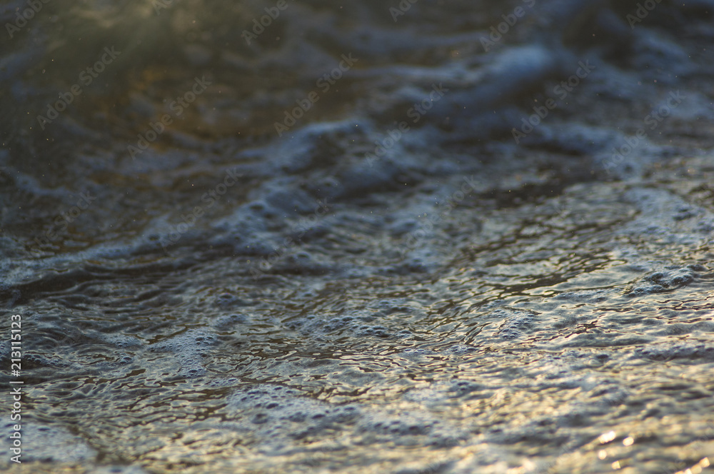 pebble stones on the sea beach, the rolling waves of the sea with foam pebble stones on the sea beach, the rolling waves of the sea with foam