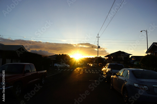 Sunrise over Kapahulu Hill with street lined with cars © Eric BVD