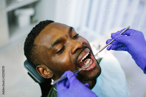 Canvastavla African male patient getting dental treatment in dental clinic