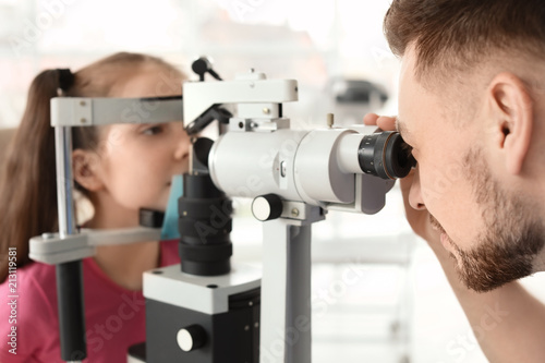 Fototapeta Naklejka Na Ścianę i Meble -  Ophthalmologist examining little girl in clinic