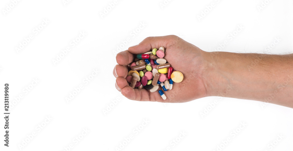 hand with medicinal pills on a white background hand with medicinal pills on a white background