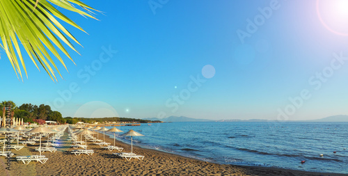 Fototapeta Naklejka Na Ścianę i Meble -  Turkey Aegean Sea coast. sunbeds and umbrellas on the beach