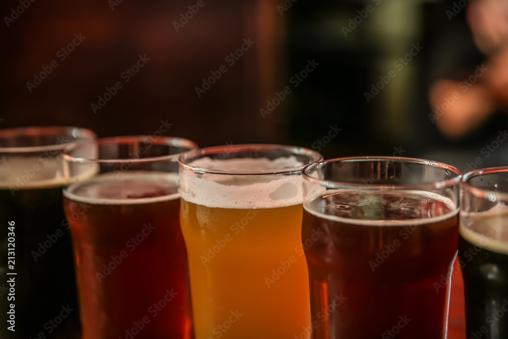 Glasses of different beer on dark background, closeup Glasses of different beer on dark background, closeup