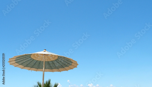sunbed umbrella on the beach and blue sky