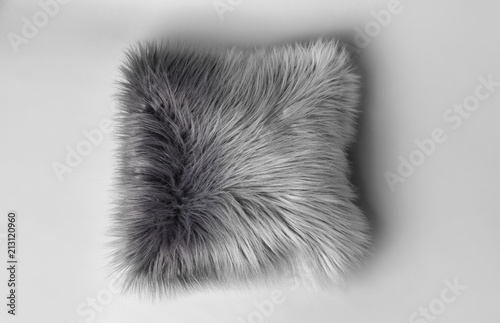 Fluffy decorative pillow on light background