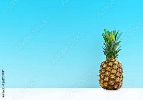 Ripe pineapple on a blue background.