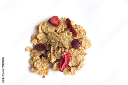 Corn flakes with dried srawberries and cherrys isolated on white photo