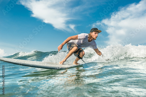 concentrated male surfer riding waves in ocean at Nusa Dua Beach, Bali, Indonesia © LIGHTFIELD STUDIOS