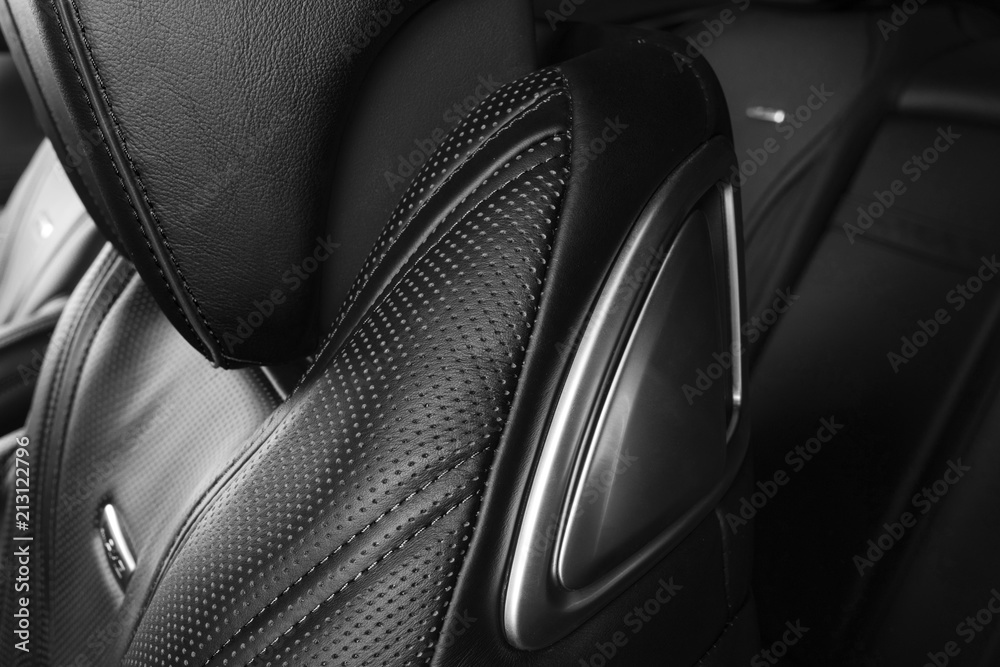 Modern Luxury car inside. Interior of prestige modern car. Comfortable leather red seats. Perforated leather. Modern car interior details. Black and white