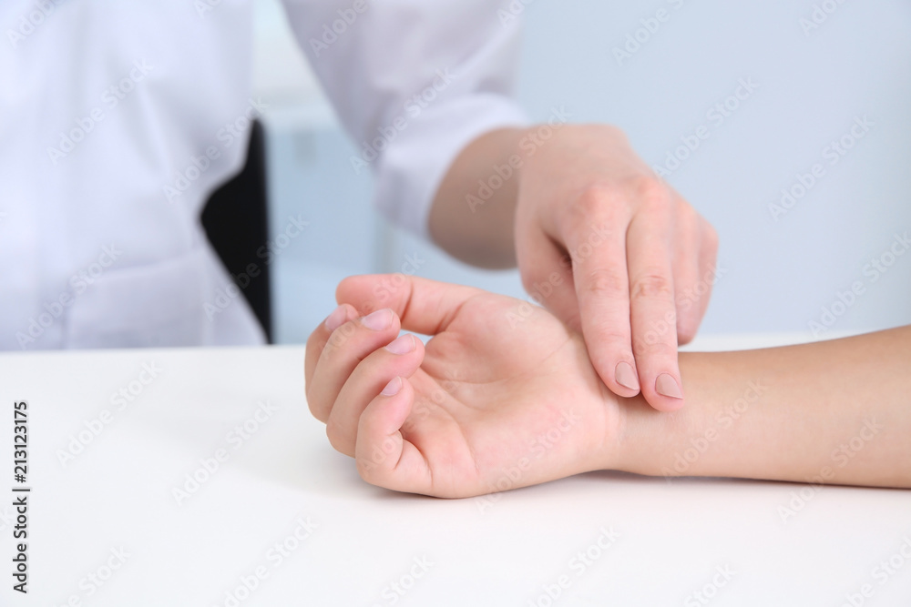 Doctor checking little boy's pulse in hospital Doctor checking little boy's pulse in hospital