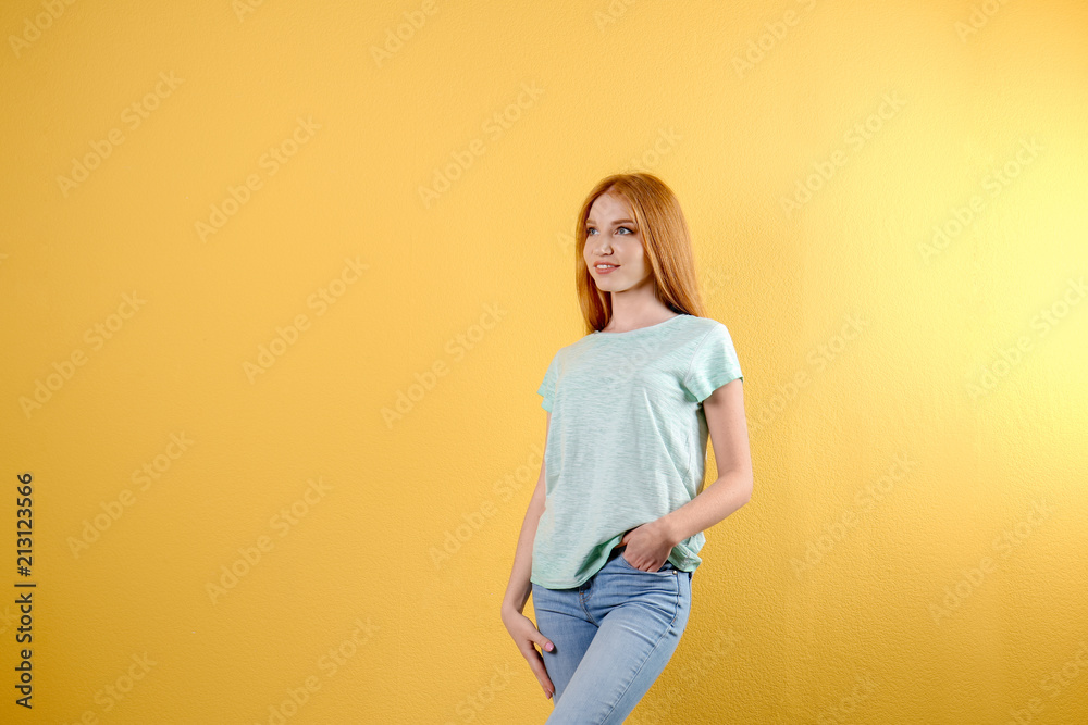 Young woman in stylish jeans on color background Young woman in stylish jeans on color background