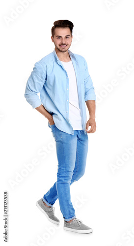 Young man in stylish jeans on white background © New Africa