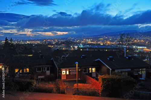 Evening view of Oslo with old historic houses in the foreground and mountains on the horizon. Norway.Europe.