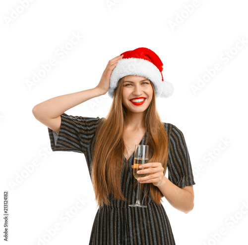 Young beautiful woman in Santa hat with glass of champagne on white background. Christmas celebration