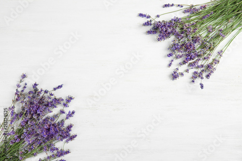 Beautiful blooming lavender flowers on light background, top view