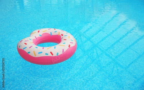 Inflatable ring floating on water in swimming pool