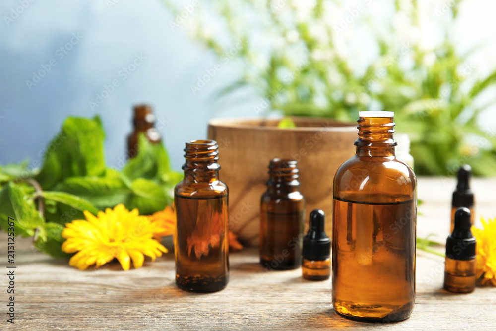 Composition with essential oils and plants on table Composition with essential oils and plants on table