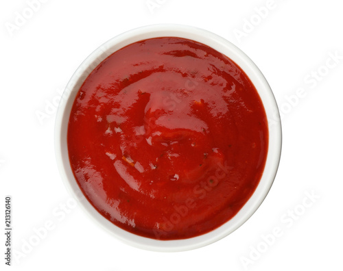 Bowl of spicy chili sauce on white background, top view