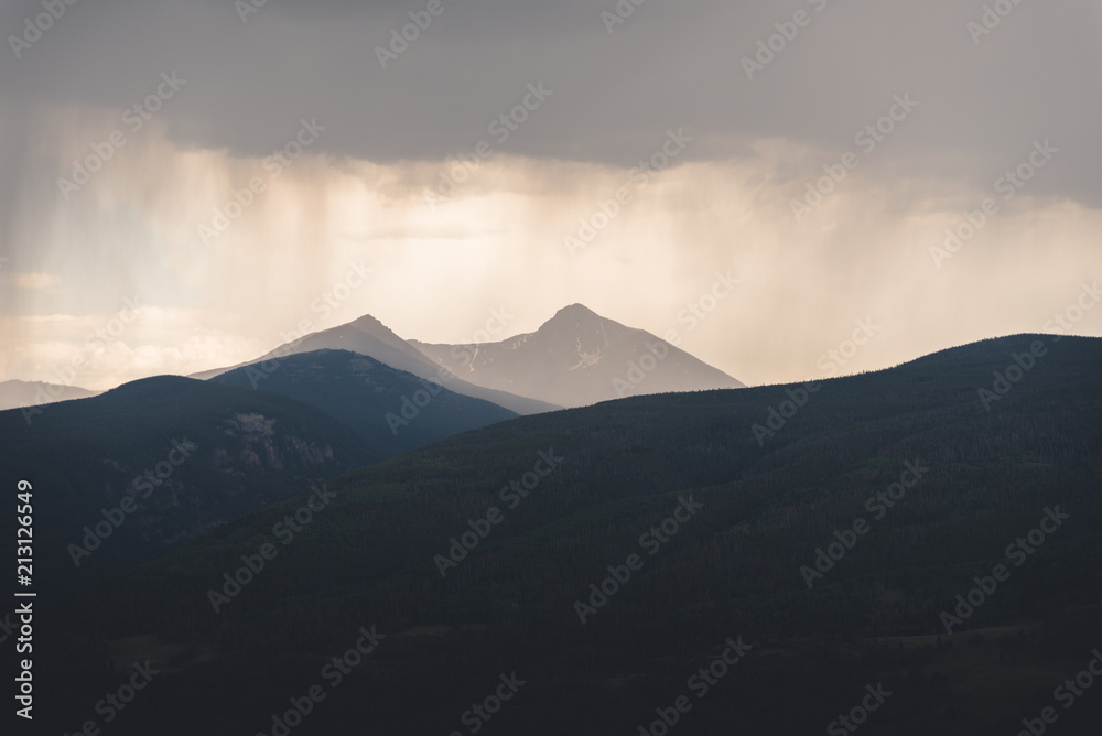 Rain falling down on a mountain peak in Colorado during the summer. 