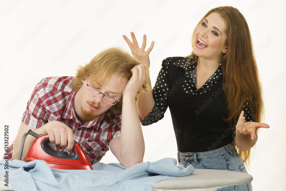 Happy woman and bored man ironing clothes Happy woman and bored man ironing clothes
