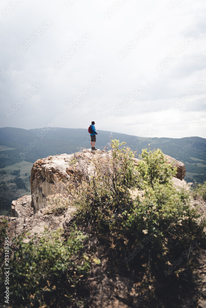A man standing at the edge of a Cliff in Colorado. 