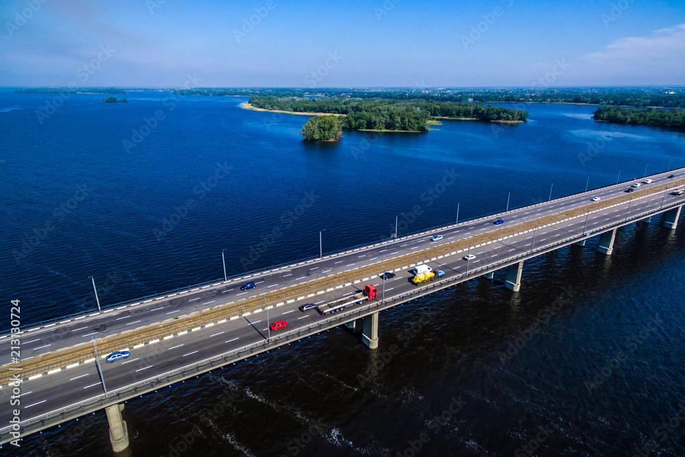 car traffic on the bridge. Drone fotography. red and yellow truck ride over the bridge