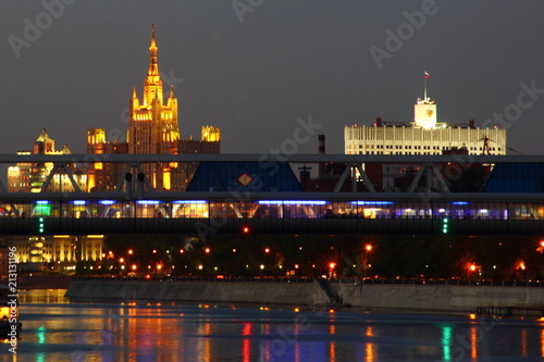 Russia, Moscow - night view from the quay of the Moscow river on the pedestrian bridge Bagration, empire building skyscraper and the Government house in the summer