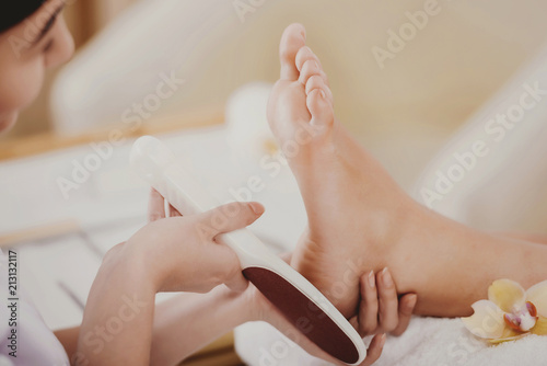 Young Beautiful Woman Does Pedicure in Spa Salon.