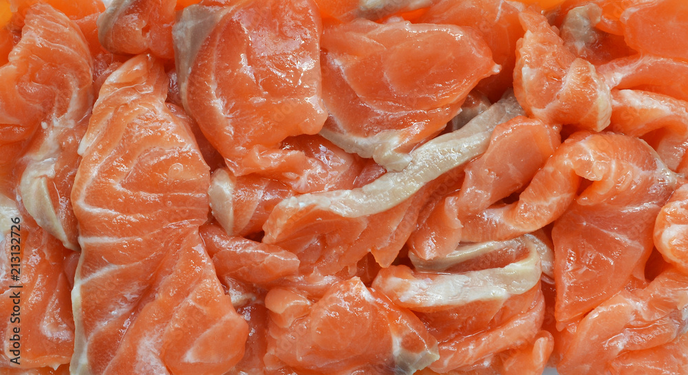 Homemade delicacy - appetizing slices of salted salmon for sandwiches close-up Homemade delicacy - appetizing slices of salted salmon for sandwiches close-up